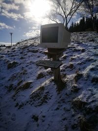 Snow on field against sky during winter