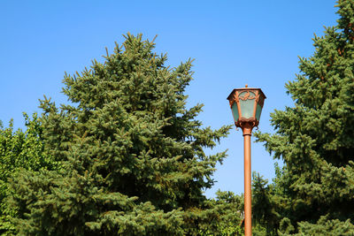 Low angle view of street light against blue sky