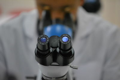 Scientist looking through microscope