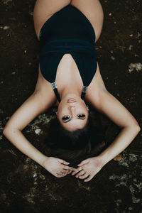 High angle portrait of young woman lying down