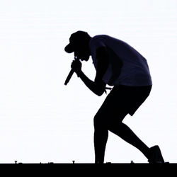 Side view of silhouette man standing against sky