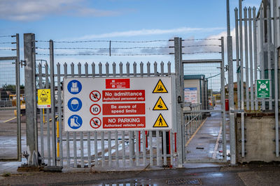 Information sign on road against sky