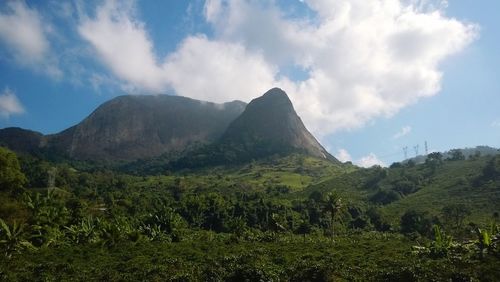 Scenic view of mountains against cloudy sky