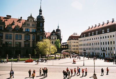 People in city against clear sky