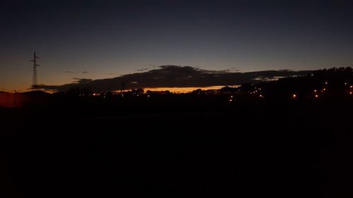 Silhouette landscape against clear sky at night