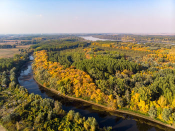 High angle view of river amidst trees against sky