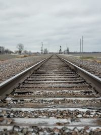 Surface level of railroad tracks against sky