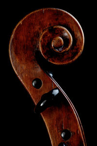 Close-up of violin against black background