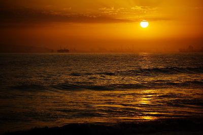 Scenic view of sea against orange sky