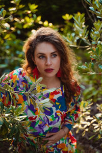 Portrait of young woman standing outdoors