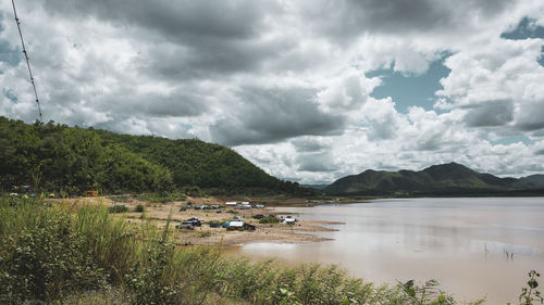 Scenic view of lake and mountains against sky