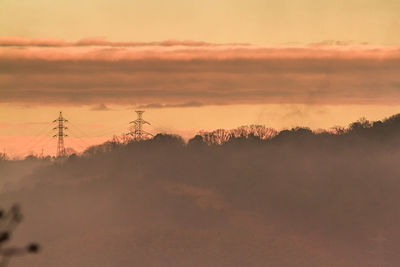 Silhouette trees against sky during sunset