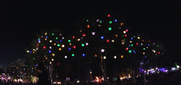 Low angle view of firework display at night