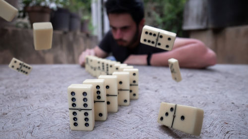 Young man playing guitar on table