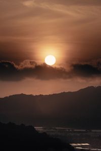 Scenic view of silhouette mountains against sky during sunset