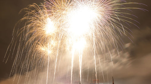 Low angle view of firework display at night