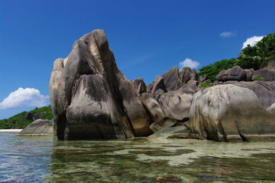 Rock formation in sea against sky seychelles