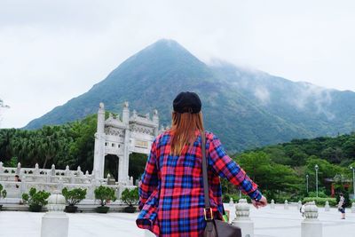 Rear view of young woman at temple