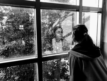 Woman looking through window