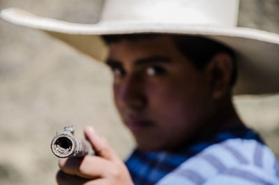 Portrait of boy holding gun
