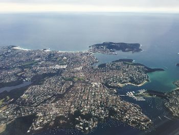 Aerial view of cityscape by sea