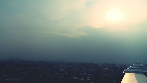 Aerial view of buildings in city against sky