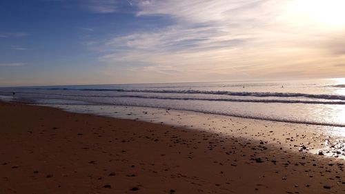 Scenic view of beach against sky during sunset