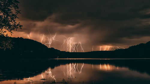 Panoramic view of lightning over lake