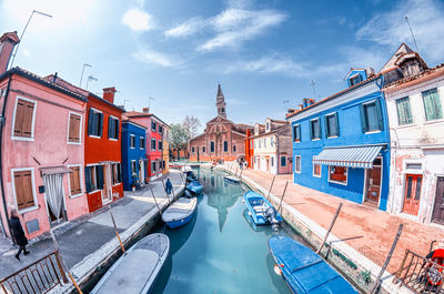 View of canal amidst buildings in city