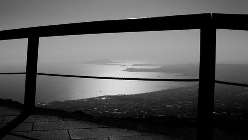 Close-up of bridge over sea against sky