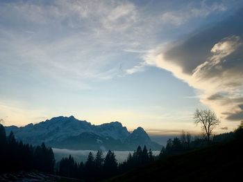 Scenic view of silhouette mountains against sky at sunset