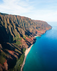 High angle view of rocks by sea against sky