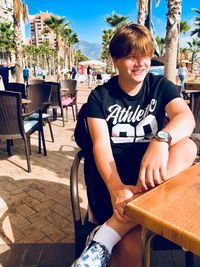 Portrait of boy sitting on chair