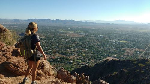 Rear view of woman on rock formation at cholla trailhead camelback mountain