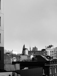 Buildings in city against clear sky