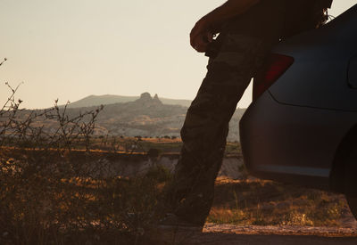 Man standing on mountain against clear sky