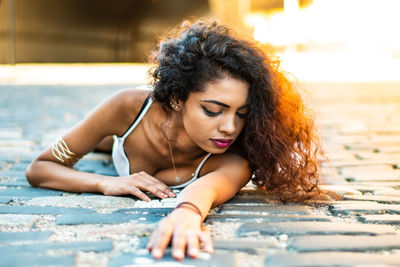 Young woman lying on swimming pool