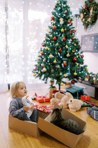 High angle view of cute girl decorating christmas tree