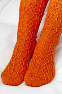 Low section of woman with orange socks