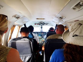 Rear view of people sitting in airplane