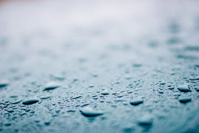 Full frame shot of raindrops on blue surface