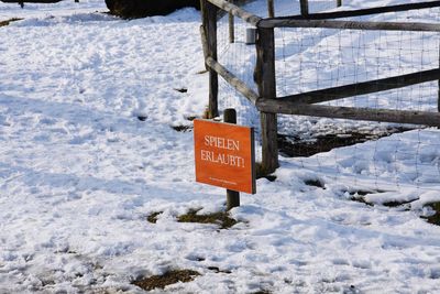 Information sign hanging on snow