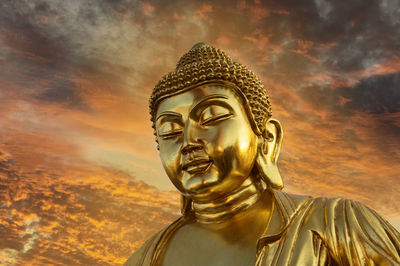 Low angle view of statue against sky during sunset