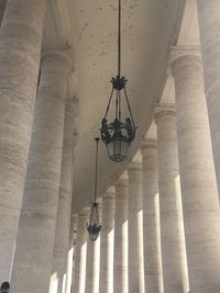 Low angle view of illuminated chandelier hanging on building 