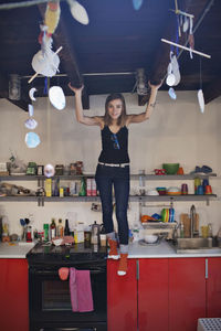 Portrait of young woman standing at home