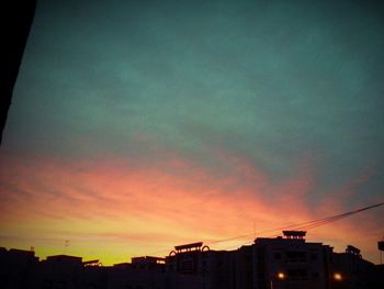 High section of building against sky at sunset