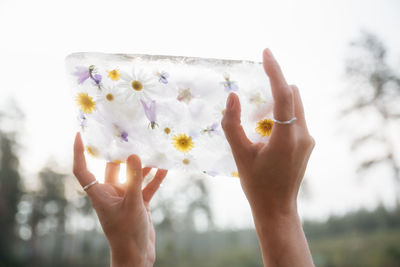 Cropped hand of woman holding american flag