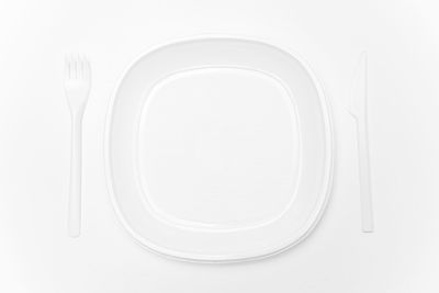 Directly above shot of empty plate against white background