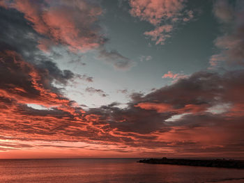 Scenic view of sea against romantic sky at sunset