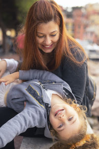 Portrait of a smiling young woman and son